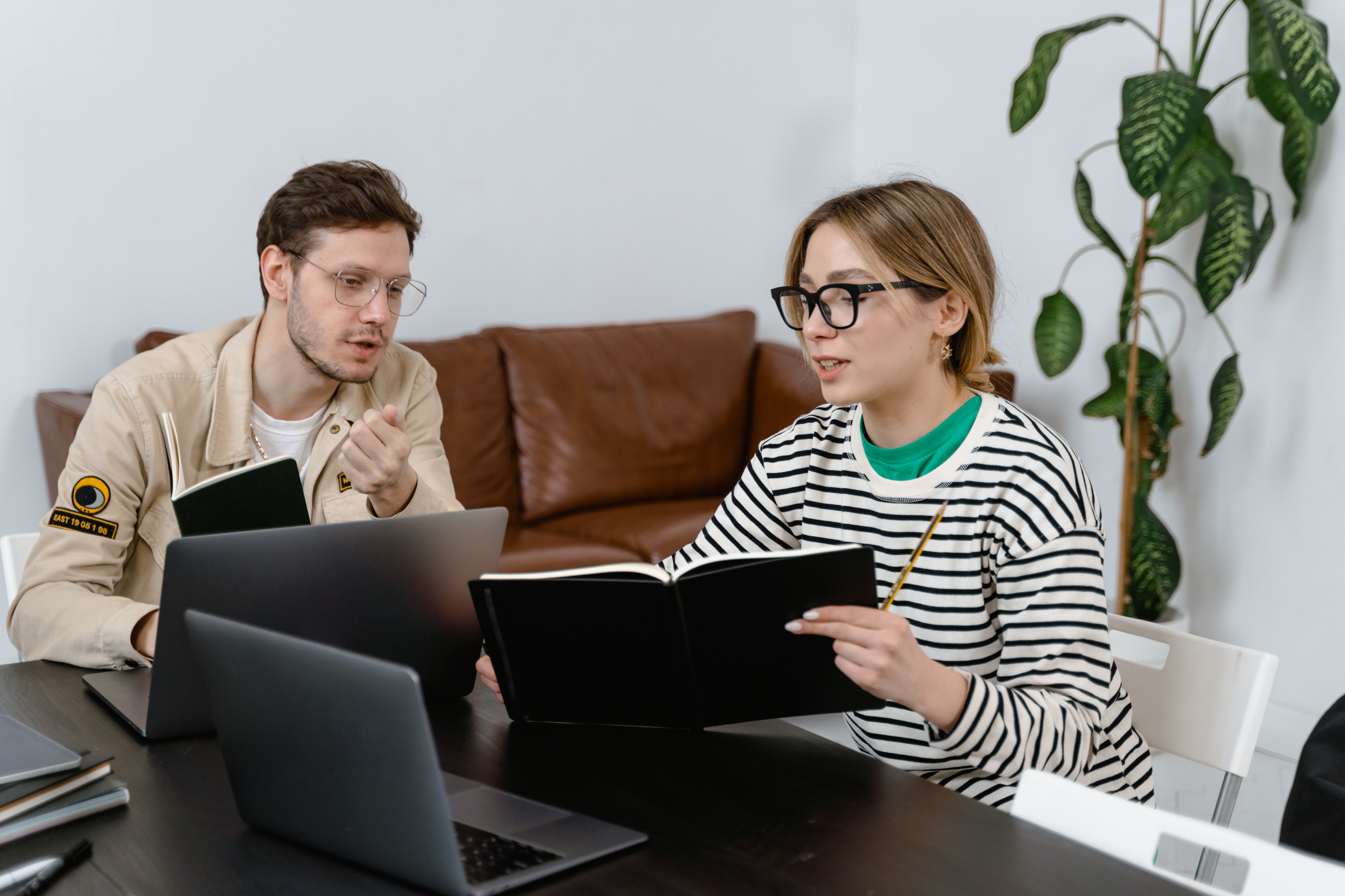 Photo by MART  PRODUCTION: https://www.pexels.com/photo/man-and-woman-discussing-in-workplace-7550581/